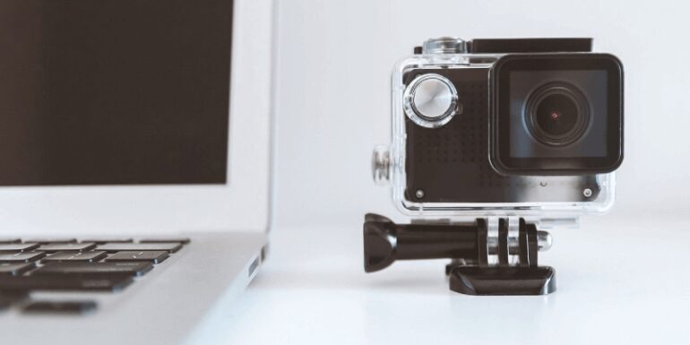 A camera next to a laptop screen.