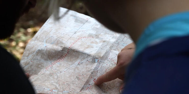 A person pointing to a map.