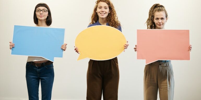 Three people holding speech bubbles.