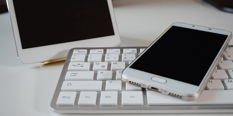 A smartphone and a tablet next to each other.